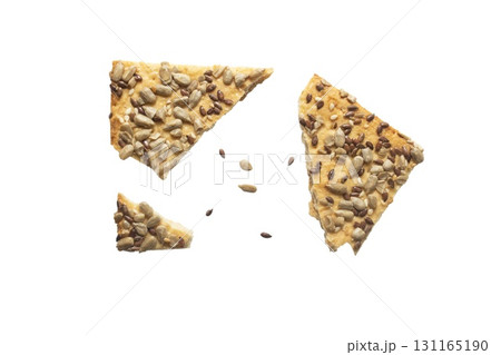 Stacked flax and sunflower seed cookies isolated on a white background are perfect for snack branding, packaging visuals, or baked goods advertising. Stacked flax and sunflower seed cookies isolated on a white background are perfect for snack branding, packaging visuals, or baked goods advertising. 131165190