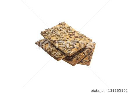 Stacked flax and sunflower seed cookies isolated on a white background are perfect for snack branding, packaging visuals, or baked goods advertising. 131165192