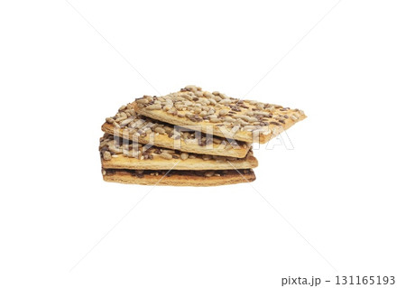 Stacked flax and sunflower seed cookies isolated on a white background are perfect for snack branding, packaging visuals, or baked goods advertising. Stacked flax and sunflower seed cookies isolated on a white background are perfect for snack branding, packaging visuals, or baked goods advertising. 131165193