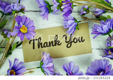 Thank You text with flowers decoration on wooden background Thank You text with flowers decoration on wooden background 131165229