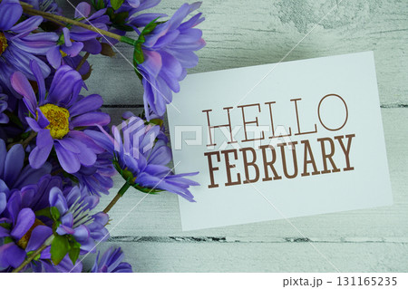 Hello February text with flowers decoration on wooden background Hello February text with flowers decoration on wooden background 131165235