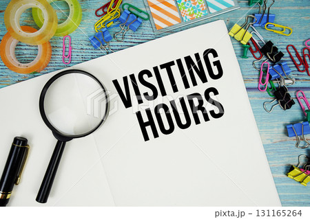 Visiting Hours text on a paper surrounded by...の写真素材 [131165264] - PIXTA