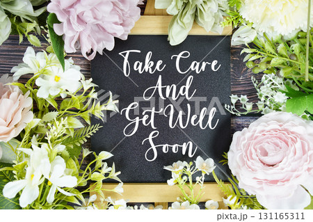 Take care and get well soon text with flowers bouquet decoration on wooden background Take care and get well soon text with flowers bouquet decoration on wooden background 131165311