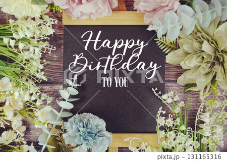 Happy Birthday to you text with flowers bouquet decoration on wooden background Happy Birthday to you text with flowers bouquet decoration on wooden background 131165316