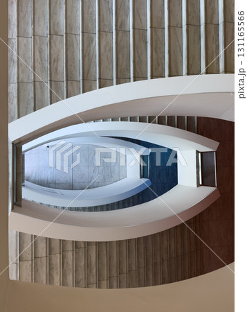 Aerial view of white curved staircases in a modern marble architectural interior 131165566