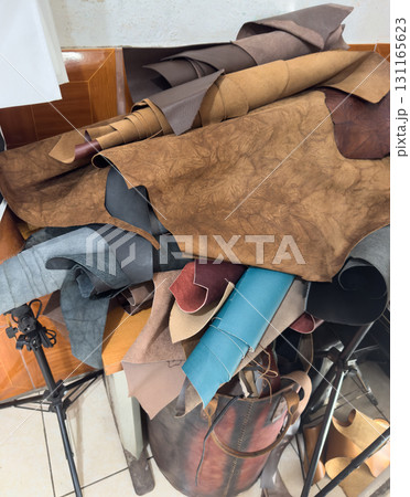 Leather scraps gathered in a workshop in the afternoon light Leather scraps gathered in a workshop in the afternoon light 131165623