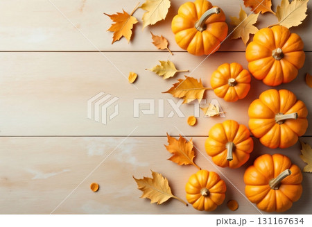 Autumn pumpkins with leaves arranged on rustic white table 131167634