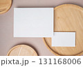 Empty white blank greeting or invitation card, name card, wooden plate on beige background. Mock up presentation. 131168006