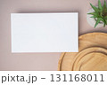 Empty white blank greeting or invitation card, cactus, wooden plate on beige background. Mock up presentation. 131168011