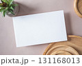 Empty white blank greeting or invitation card, cactus, wooden plate on beige background. Mock up presentation. 131168013