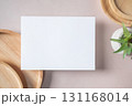Empty white blank greeting or invitation card, cactus, wooden plate on beige background. Mock up presentation. 131168014
