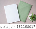 Empty white blank greeting or invitation card, green envelope, cactus on beige background. 131168017