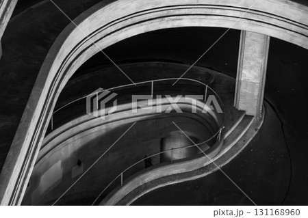 Monochrome spiral staircase captures flowing curves, dramatic perspective, and architectural beauty Monochrome spiral staircase captures flowing curves, dramatic perspective, and architectural beauty 131168960