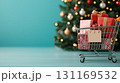 close up of shopping cart filled with colorful gifts, decorated for holidays, set against festive background with Christmas tree 131169532