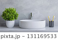 modern bathroom sink with sleek design, surrounded by greenery and toothbrushes, creates fresh and inviting atmosphere 131169533
