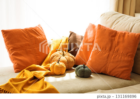 Autumnal living room decor with corduroy pumpkins and cozy pillows. Autumnal living room decor with corduroy pumpkins and cozy pillows. 131169896