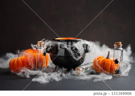 Halloween Cauldron with Pumpkins, Spiders and Cobwebs 131169906