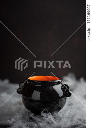Halloween Cauldron with Pumpkins, Spiders and Cobwebs 131169907