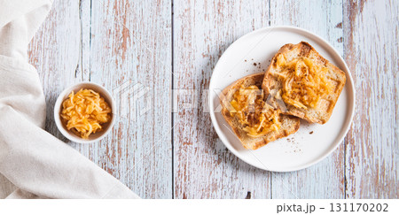 Sweet apple jam on croutons on a plate on the table top view web banner 131170202