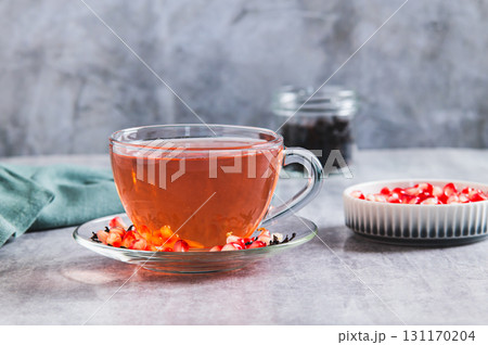 Detox green pomegranate tea in a cup on the table 131170204