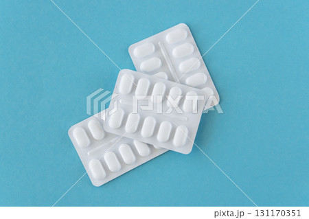 Much medical pills and drugs in white plastic package on the blue background. Healthcare concept. 131170351