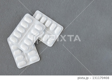 Much medical pills and drugs in white plastic package on the gray background. Healthcare concept. Space for text. 131170408
