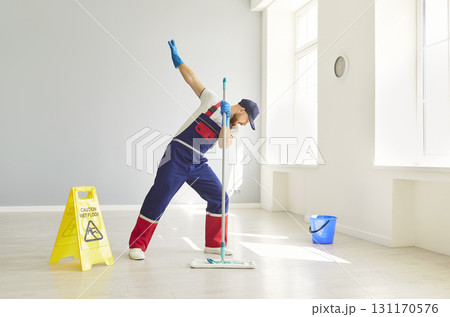 Man Cleaner Mopping Floors And Dancing Happily During Housecleaning Man Cleaner Mopping Floors And Dancing Happily During Housecleaning 131170576