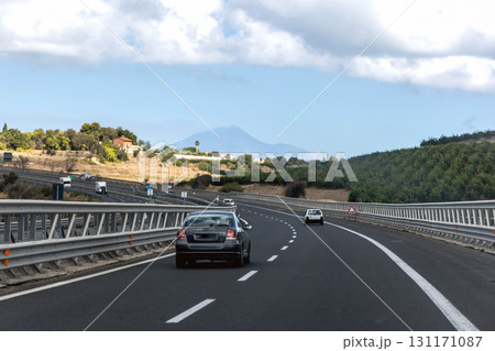 Open road in Sicily with scenic mountain and bright sunny sky Open road in Sicily with scenic mountain and bright sunny sky 131171087