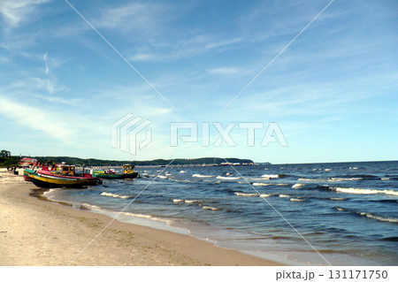 Polish Baltic Sea beautiful blue sea waves colorful fishing boats beacch sand 131171750