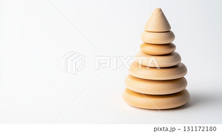 Eco-friendly wooden stacking toy pyramid isolated on white, symbolizing sustainable play. 131172180