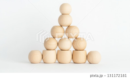 Eco-friendly wooden stacking pyramid toy with natural finish, isolated on a white background for sustainable design. 131172181