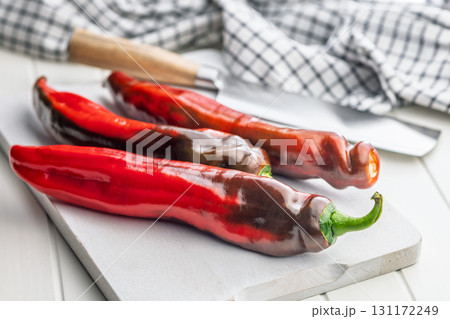 Corno di Toro Rosso pepper. Red paprika vegetable on cutting board. 131172249
