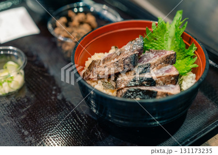 KOCHI, JAPAN - may 2 2025 Seared bonito tataki served on a plate  KOCHI, JAPAN - may 2 2025 Seared bonito tataki served on a plate  131173235