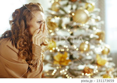 Emotional Holiday Moment by Christmas Tree 131173659