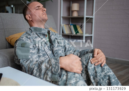 Soldier sitting on the floor suffering from post-traumatic stress disorder Soldier sitting on the floor suffering from post-traumatic stress disorder 131173929