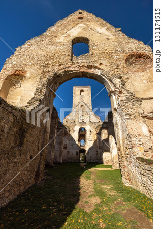 The Katarinka, ruins of a Franciscan monastery and church in Slovakia, Europe. Ruined building shows weathering of walls and tower in an old architectural landscape against a blue sky The Katarinka, ruins of a Franciscan monastery and church in Slovakia, Europe. Ruined building shows weathering of walls and tower in an old architectural landscape against a blue sky 131174515