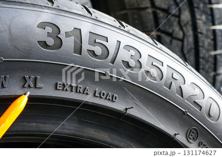 Close-up of tire sidewall with size marking 315-35R20 and XL extra load specification visible 131174627