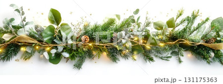 Festive garland with pinecones and eucalyptus accented by string lights and dusting of snow 131175363