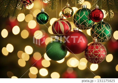 A close-up shot of elegant Christmas tree ornaments hanging on a blurred background of festive lights. 131175825