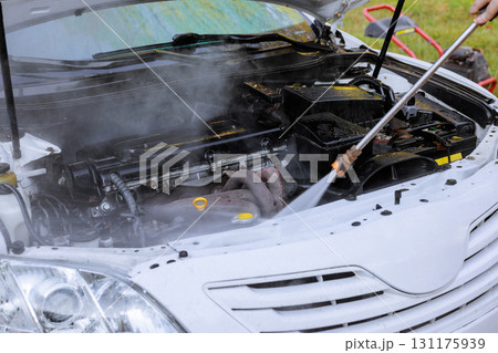 Cleaning car engine with steam for better maintenance performance. 131175939
