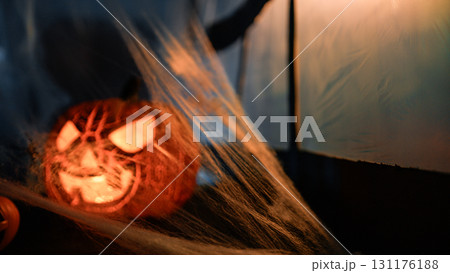 Halloween Pumpkin And Scary Cobwebs In Front Of A Window 131176188