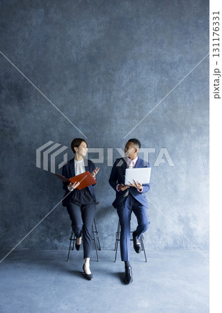 打ち合わせをするビジネスマンとビジネスウーマン 打ち合わせをするビジネスマンとビジネスウーマン 131176331