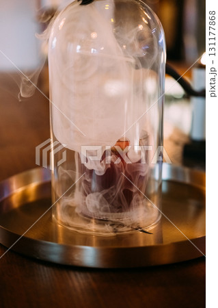 Cocktail smoke. Serving drink. Glass cloche with aroma beverage in swirling fume cloud. Pub modern technique presenting alcoholic liquid. 131177868
