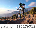 Mountain adventure: biker climb, trail ride, terrain challenge, slope path, uphill struggle, outdoor thrill, rocky landscape, gear movement, pedal journey, altitude effort, summit pursuit nature rush. 131179712