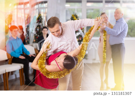 Couple performing dip move in dance at New Year celebration in office Couple performing dip move in dance at New Year celebration in office 131181307