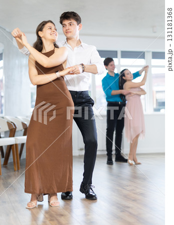 Latin American guy and girl performing kizomba in dance studio Latin American guy and girl performing kizomba in dance studio 131181368