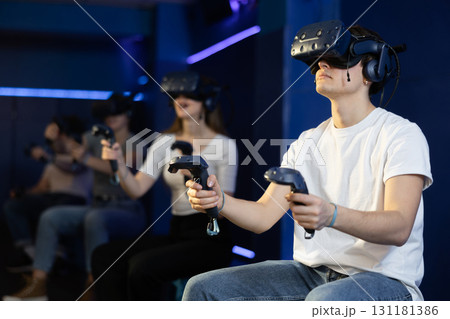 Man using virtual reality glasses delighted with videogames and new tech Man using virtual reality glasses delighted with videogames and new tech 131181386