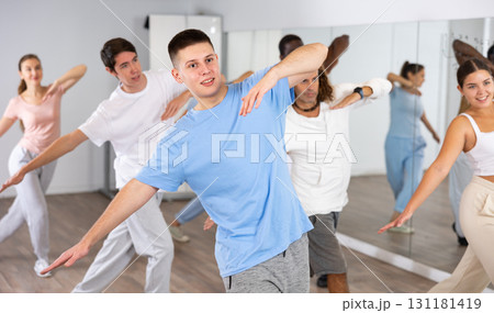 Group of different people rehearsing dance in dance studio Group of different people rehearsing dance in dance studio 131181419