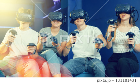 Group of excited young people playng virtual game 131181431