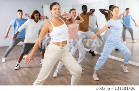 Group of different people rehearsing dance in dance studio Group of different people rehearsing dance in dance studio 131181436